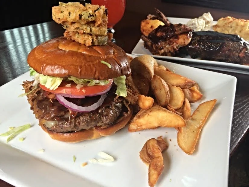 Cask Burger : half-pound Certified Angus Beef burger topped with Big D's BBQ pulled pork, caramelized onions, maple Cajun bacon, Vermont cheddar cheese and chipotle mayo on a toasted pretzel bun, topped with a fried pickle chips ($11.75)
