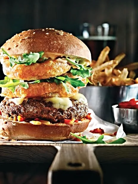 Fenway Burger - battered onion rings, red pepper relish, aged white cheddar, arugula, hand smashed patty certified Angus patty on a house brioche-style bun ($17.00)