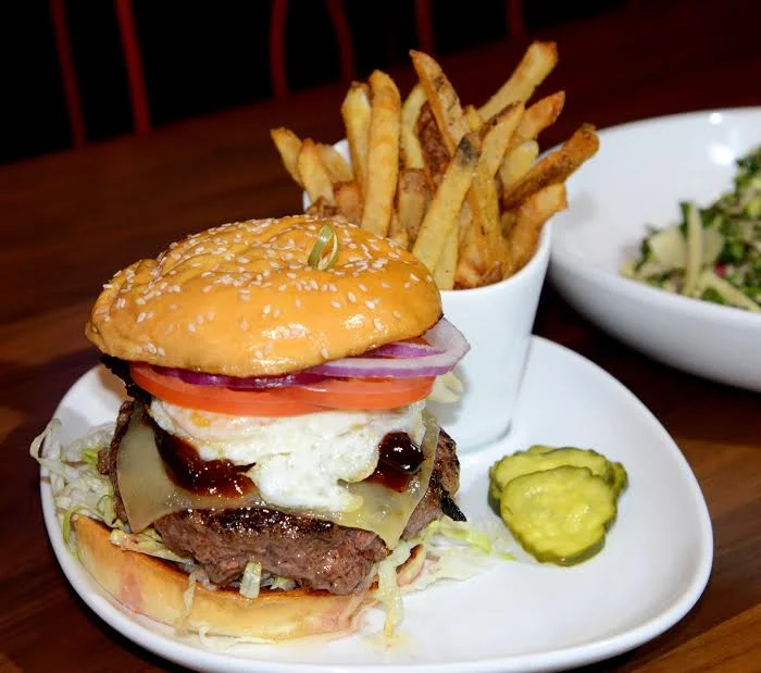 Tony C's Sports Bar and Grill - #25 Burger – Vermont cheddar, crispy pork belly, fried egg, smokey hoisin sauce, sesame brioche, served with hand-cut French Fries 