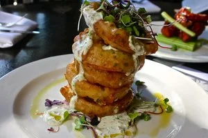 “Crooked [Hillary] Tree IPA Battered Onion Rings” with a private server of dipping sauces&nbsp;
