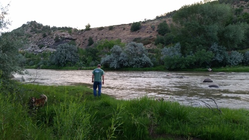 At home with his dog Gulliver, on the Animas River, Durango, CO.