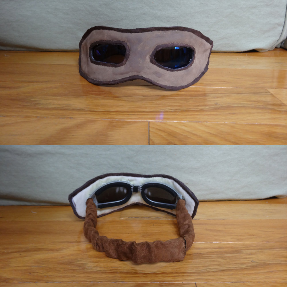  Goggles: Lenses from a cheap pair of sunglasses, wrapped in microsuede-covered vinyl (from an old diaper changing pad. Hey, I don’t just have a lot of vinyl lying around, you know?). I also attached a tiny mag-lite to the left side so she’d have Rey