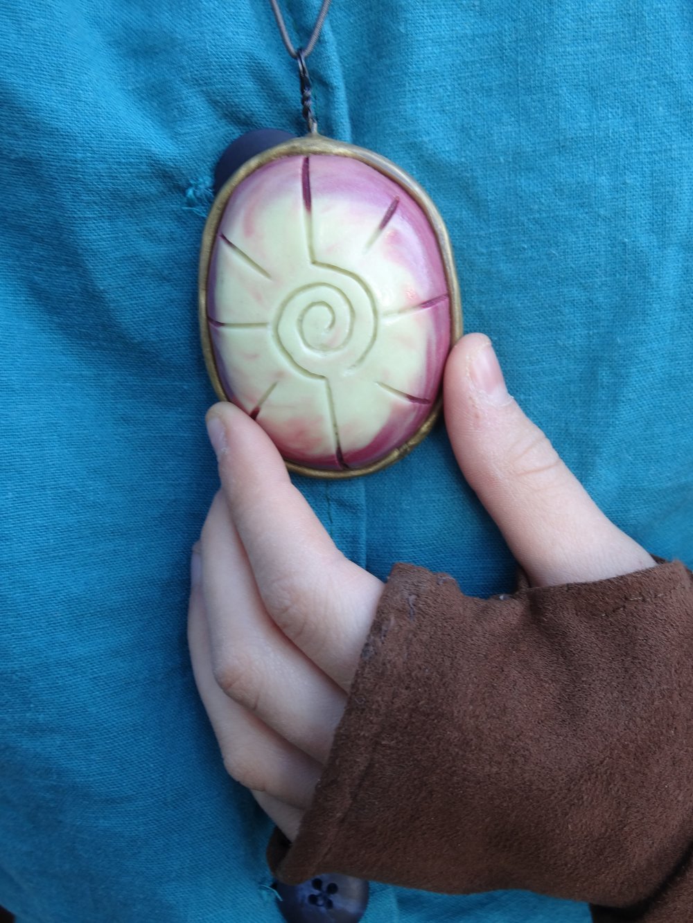  I made the amulet from Sculpey (I combined regular Sculpey with the glow-in-the-dark variety so at least it glowed some of the time).  