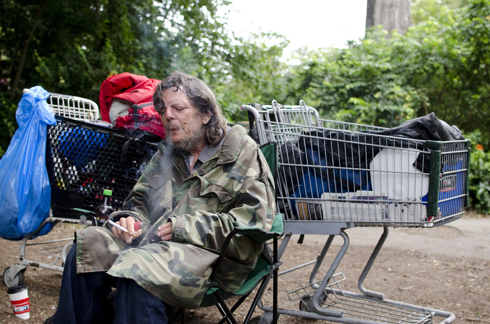 Roy sits with his belongings near Fulton and 7th ave in San Francisco's Golden Gate Park. Roy has been squatting in Golden Gate Park for many of the 10 years that he's been homeless in San Francisco. He likes the park because it's more quiet and comfortable than most places in San Francisco. Camera Settings: 1/160 f/2.8 iso 320