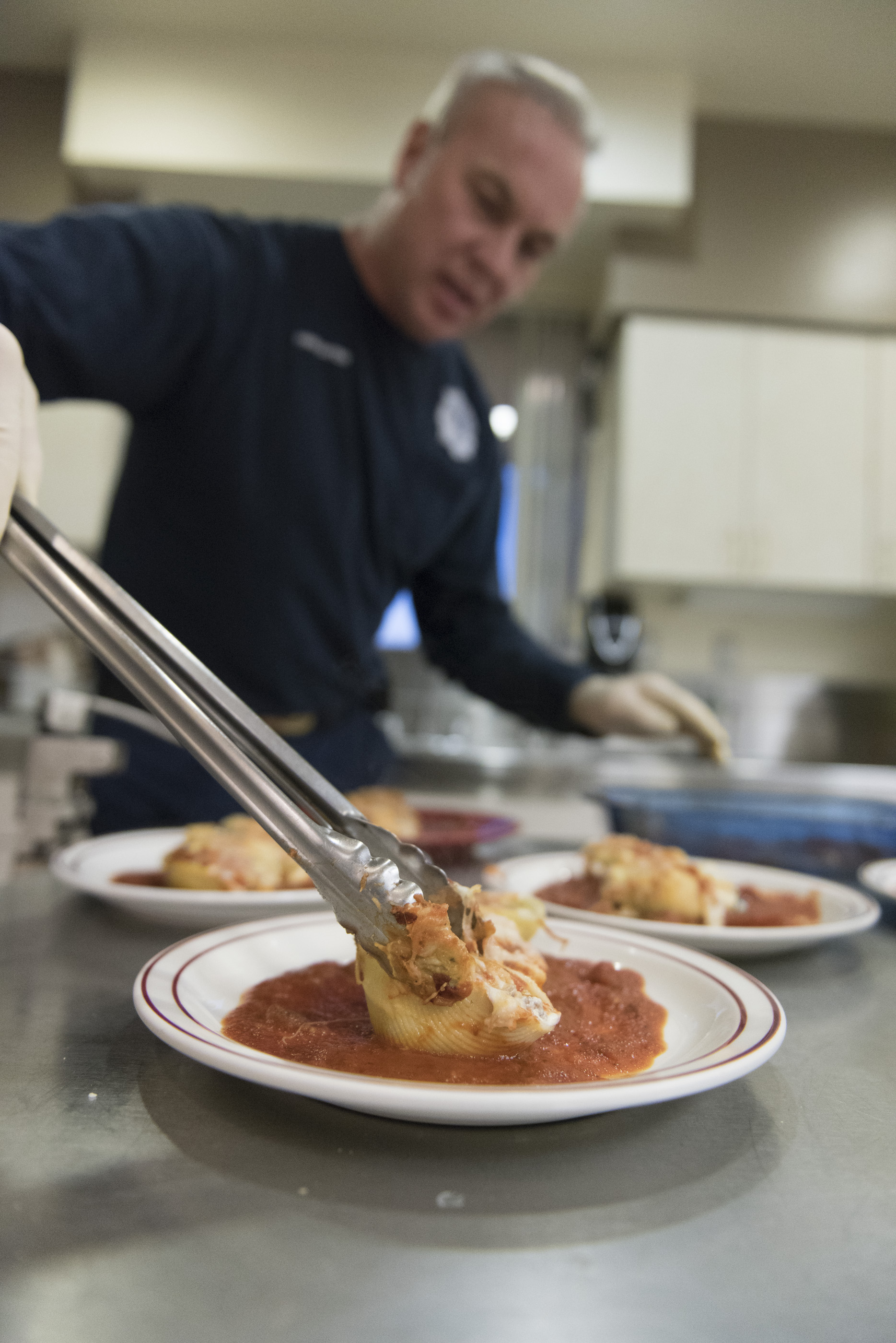 Firefighter Ted Ramey plates Italian stuffed shells as he prepares to serve dinner to the six man crew at Las Vegas Fire & Rescue Fire Station 41 in Las Vegas Monday, Jan. 11, 2016. In a few seconds dinner will be put on hold as the firehouse crew responds to a call. Jason Ogulnik/Las Vegas Review-Journal