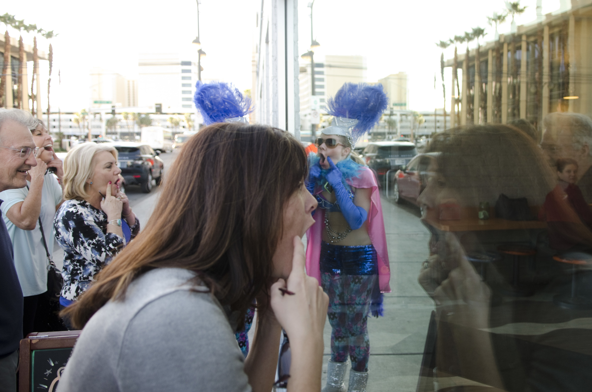 Sarah Jessica Rhodes, who performs as "Cuddles," center, and her audience show their o faces to the staff and patrons through the window at O Face Doughnuts at 124 S. 6th St. during a performance/tour of Alibi in downtown Las Vegas Saturday, Mar. 7, 2015. O face Doughnuts closed in Dec. 2015.