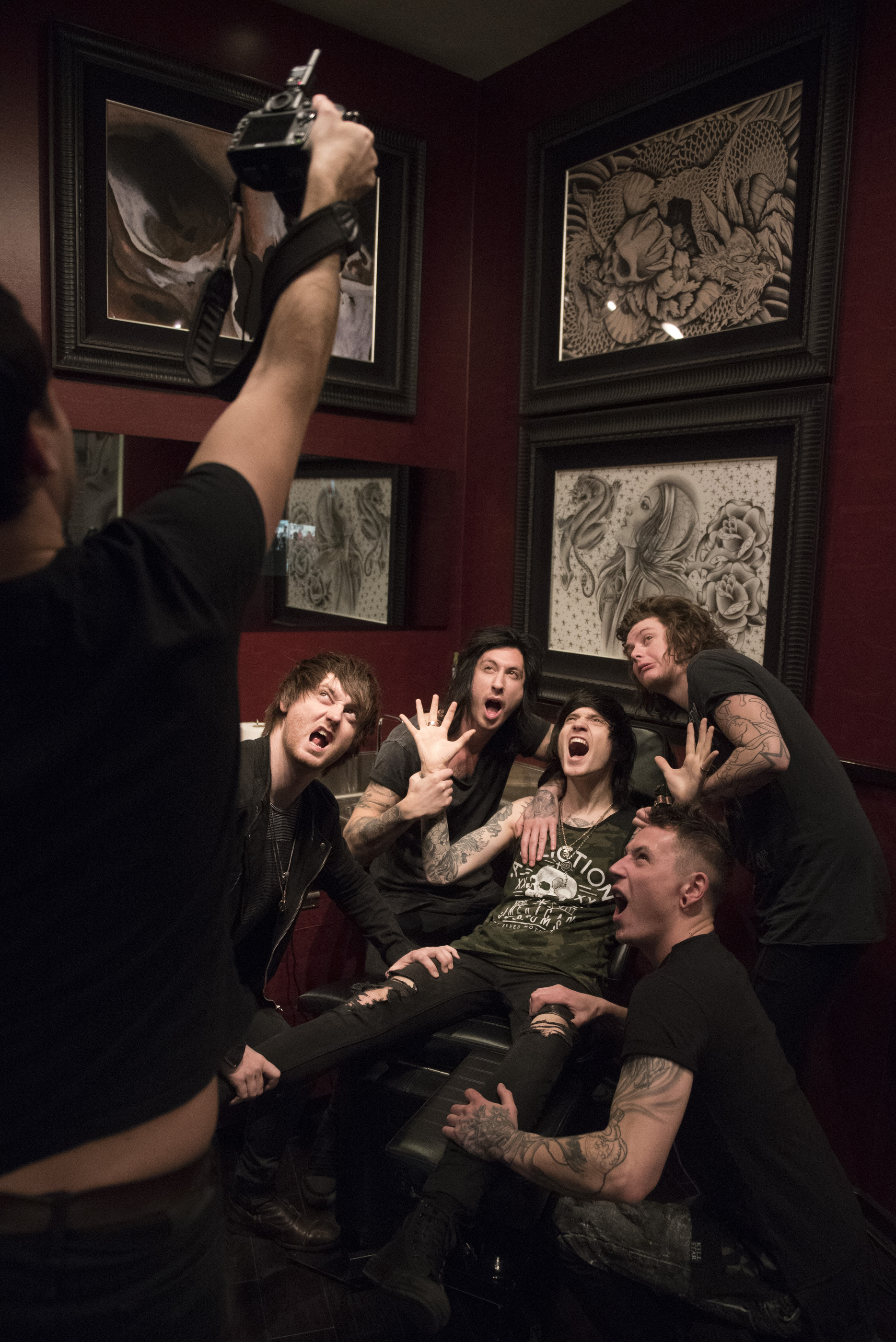 Andrew Lipovsky, left, takes a "hail mary" style photo of Asking Alexandria for a Kerrang! magazine photoshoot at Hart & Huntington Tattoo at Hard Rock Hotel & Casino in Las Vegas Saturday, Feb. 6, 2016. Photo by Jason Ogulnik