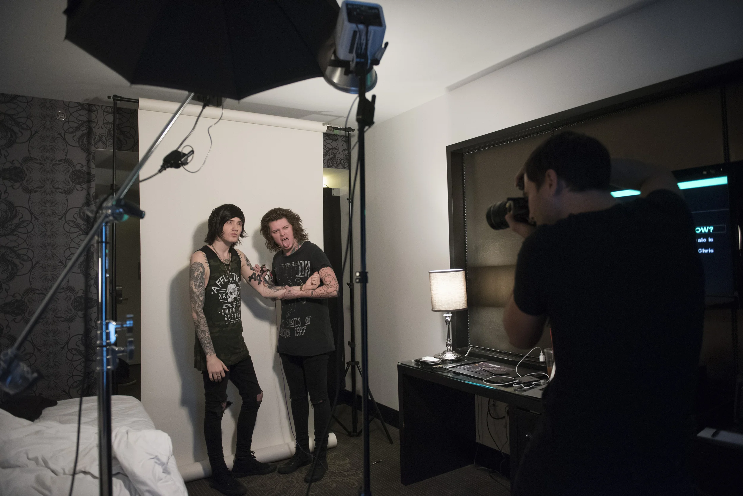Andrew Lipovsky, right, takes a photo of Asking Alexandria's Denis Stoff, left, and Ben Bruce for a Kerrang! magazine photoshoot at Hart & Huntington Tattoo at Hard Rock Hotel & Casino in Las Vegas Saturday, Feb. 6, 2016. Photo by Jason Ogulnik