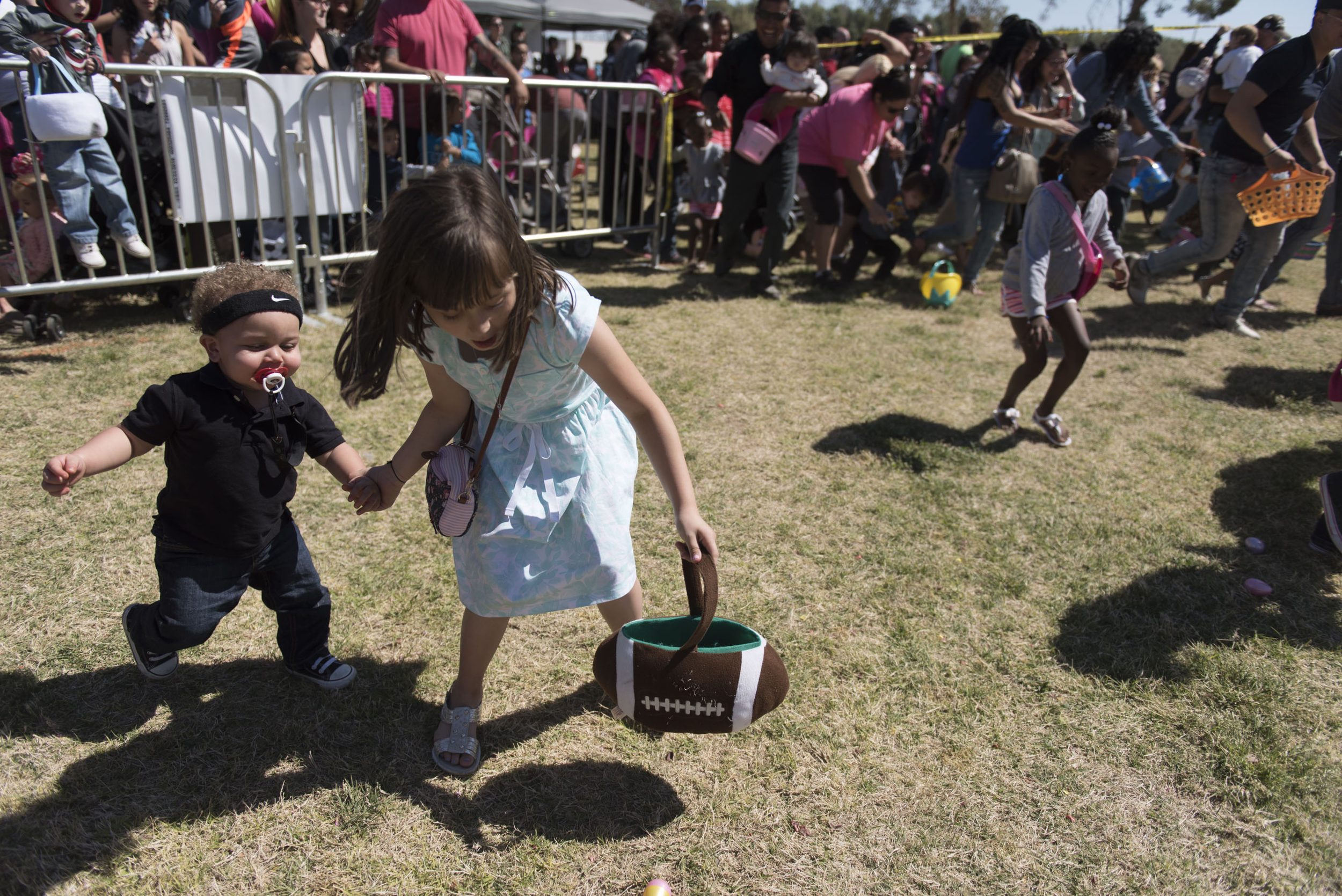 Darvell Hill, 1, left, is helped by Micaela Azevedo, 9, in collecting easter eggs during the 3rd annual Easter Festival at Craig Ranch Regional Park in North Las Vegas Saturday, March 26, 2016. The Christian Hope Project and the Las Vegas police Northeast Area Command helped to put on the event. Jason Ogulnik/Las Vegas Review-Journal