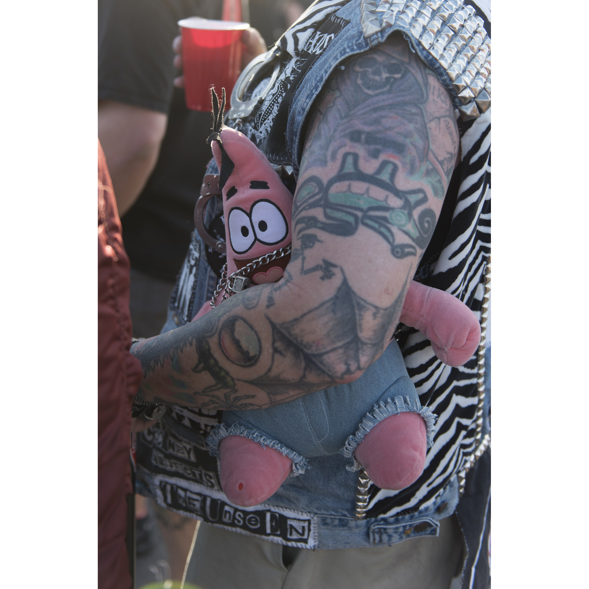 A festivalgoer carries a stuffed animal and a beer as The Bronx performs during the 18th annual Punk Rock Bowling & Music Festival in downtown Las Vegas Saturday, May 28, 2016.