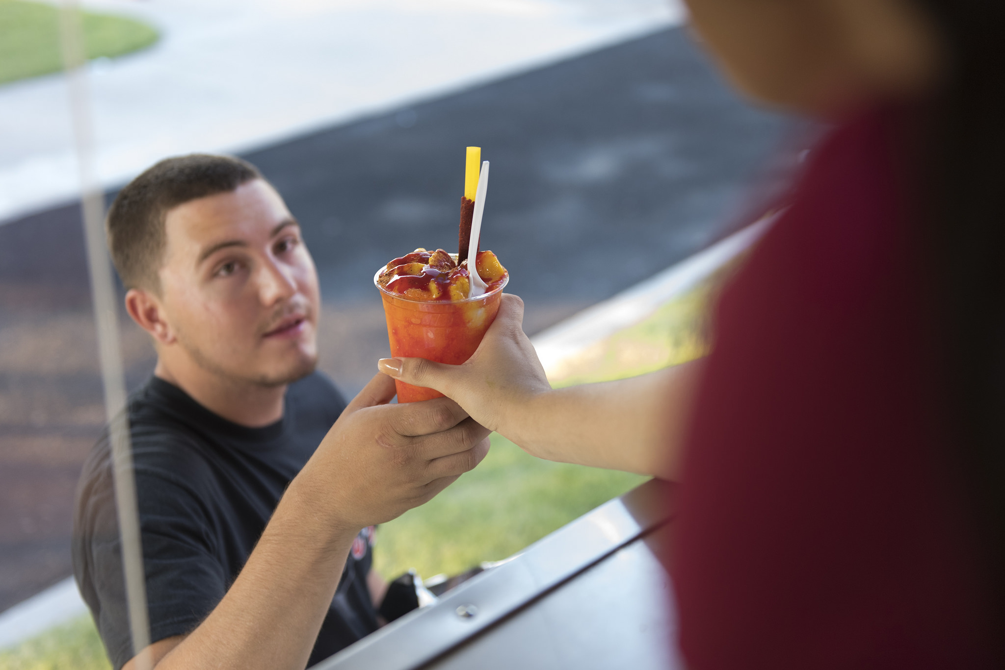 Ryan Silva, left, is handed a mangonada by Amanda Cuadra at Frankie's Ice Cream Trucks at Lewis Family Park in Las Vegas Friday, June 24, 2016. Jason Ogulnik/Las Vegas Review-Journal