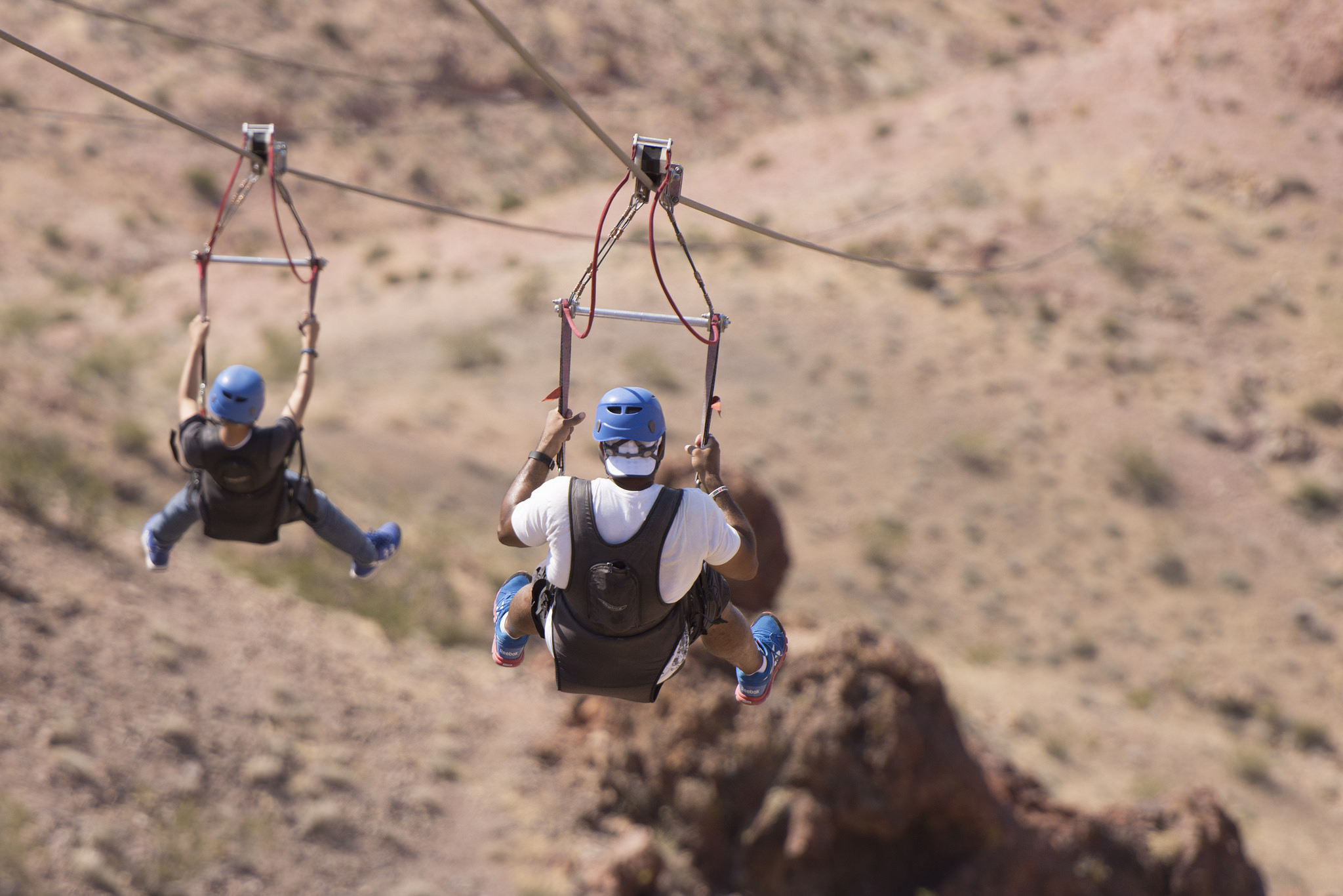 Tim Hicks, right, and his son, Ian Hicks, 13, left, of Seattle, ride a zip line in Bootleg Canyon Mountain Bike Park in Boulder City Wednesday, Aug. 17, 2016. The tour is led by Flightlinez Bootleg Canyon. Jason Ogulnik/Las Vegas Review-Journal