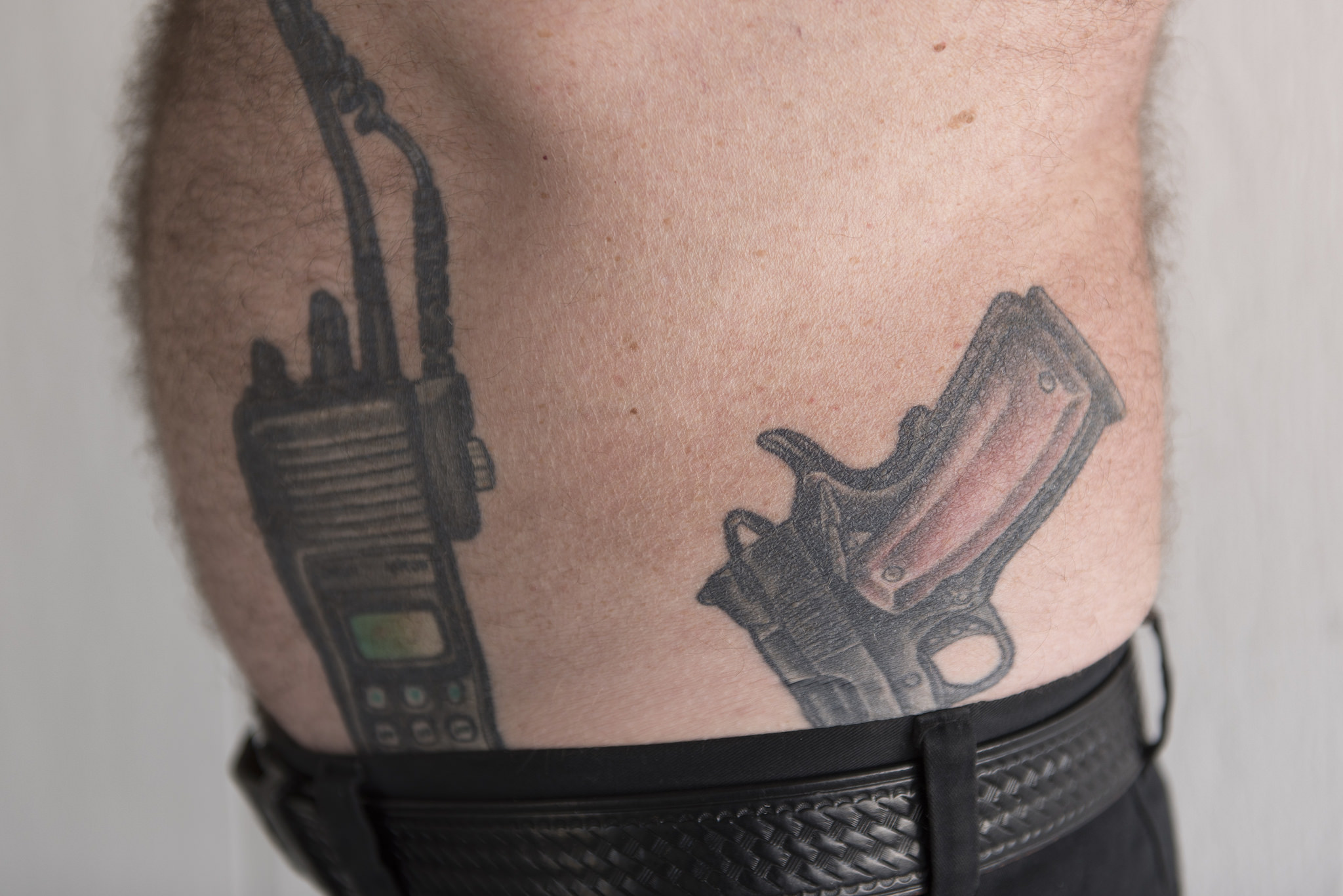 Retired Capitol Police officer and Nevada Highway Patrol trooper Brad Carson shows tattoos of a police radio and a Guncrafter Industries .50 caliber handgun at Carson's residence in Las Vegas Monday, Aug. 15, 2016. Carson deals with physical pain after being hit by a drunk driver while writing a ticket for another driver in 2004. Jason Ogulnik/Las Vegas Review-Journal