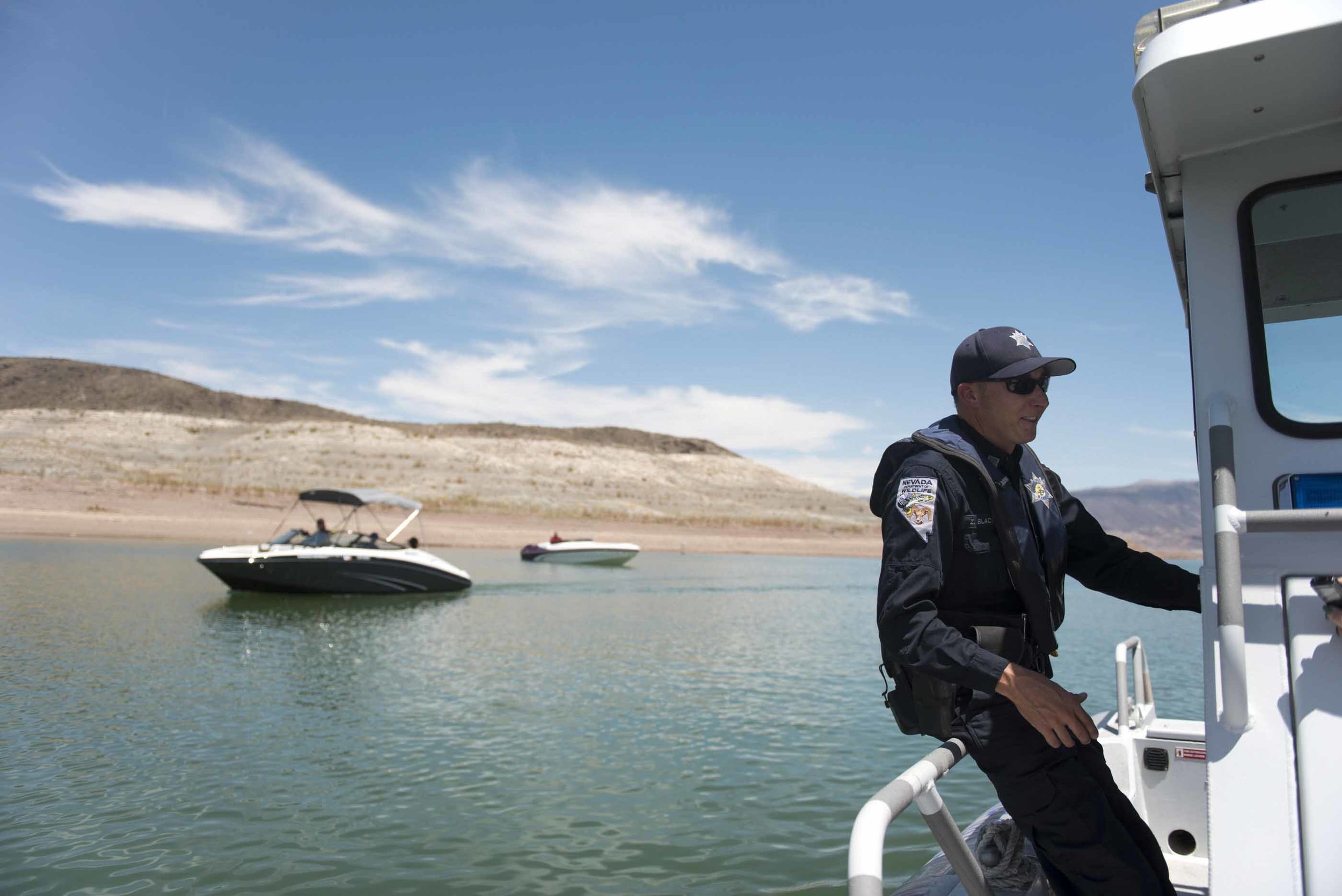 On Friday, July 3, 2015, near Boulder City, Nevada Department of Wildlife Game Warden Zach Blackwood gives a tour to show Lake Mead's receding waterline and the dangers it poses to boaters.