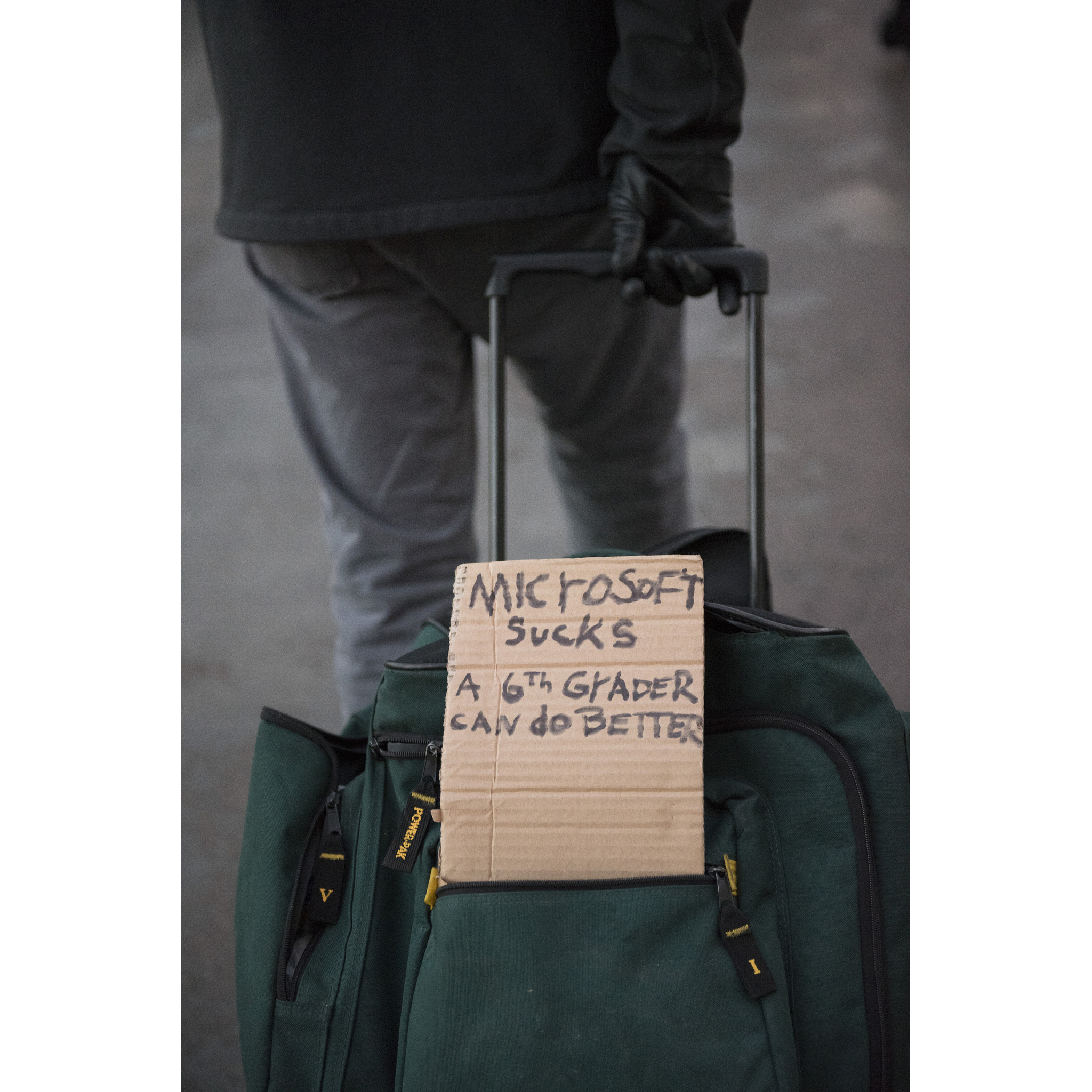 A man displays an anti-Microsoft sign for CES attendees outside of the Venetian hotel-casino in Las Vegas, Thursday, Jan. 5, 2016.