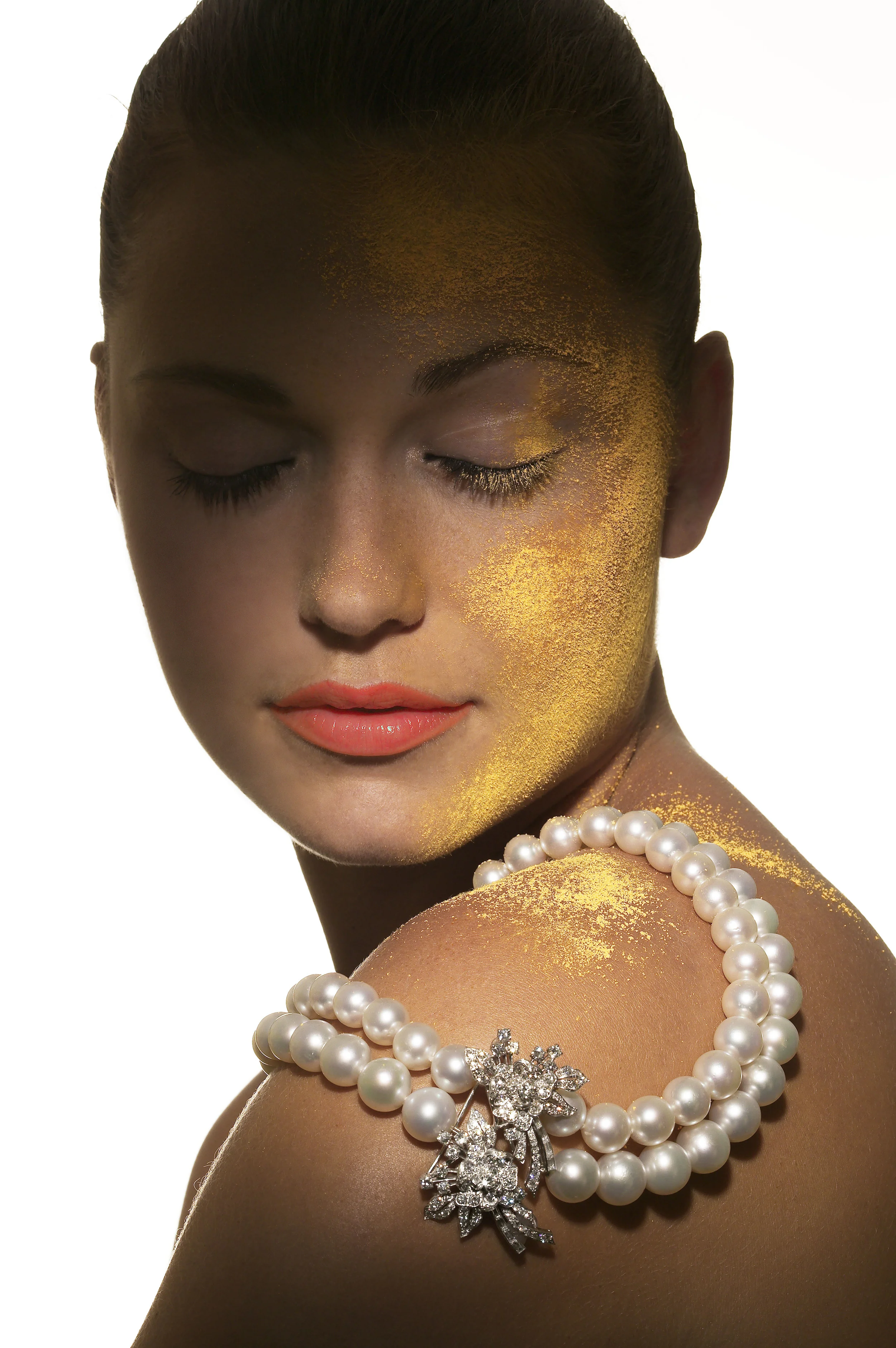 Jewellery Magazine model with pearls on her shoulder