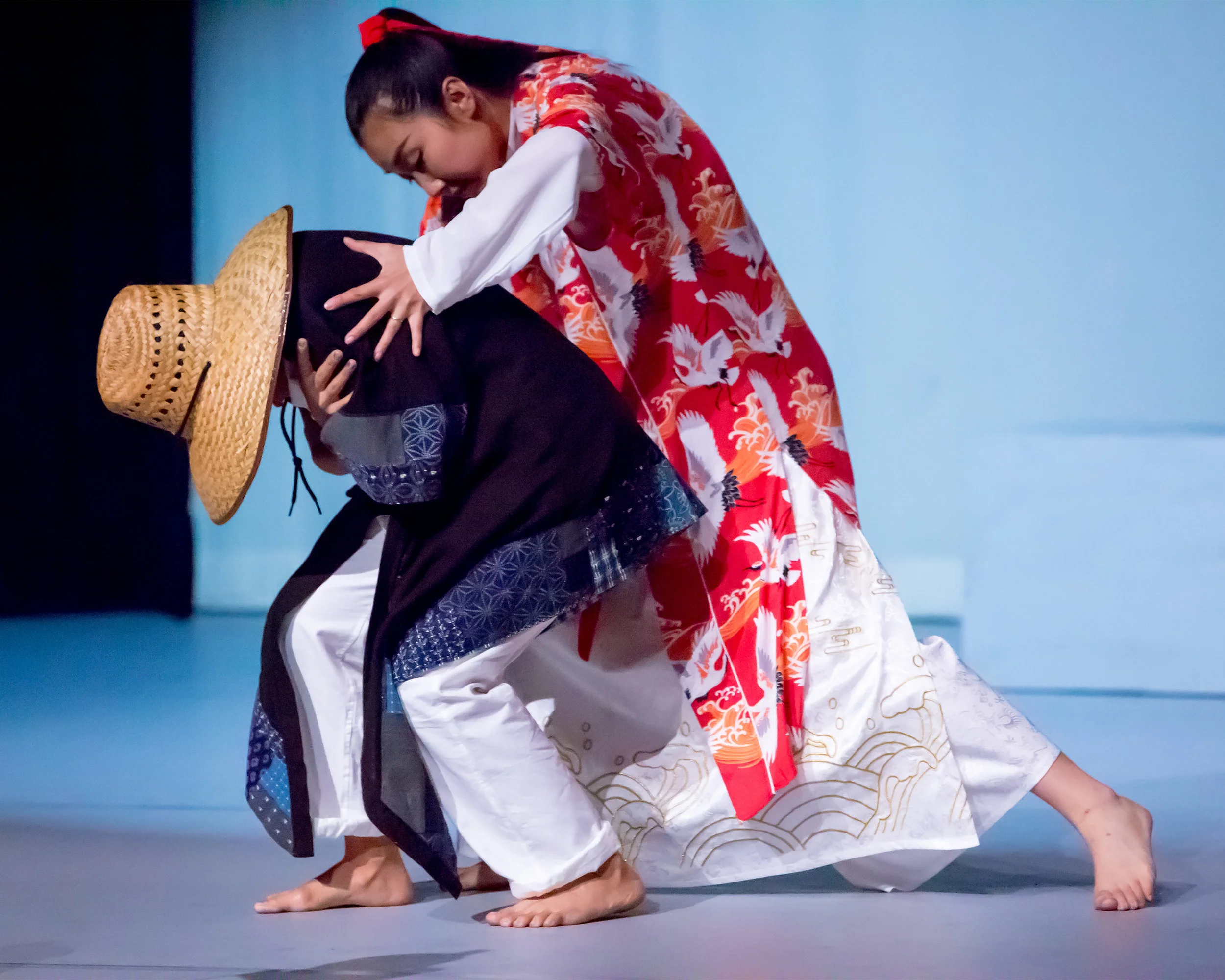 The Lord of the Cranes (choreographed and danced by Jingqiu Guan) takes pity on a shivering pauper (Kristianne Salcines)