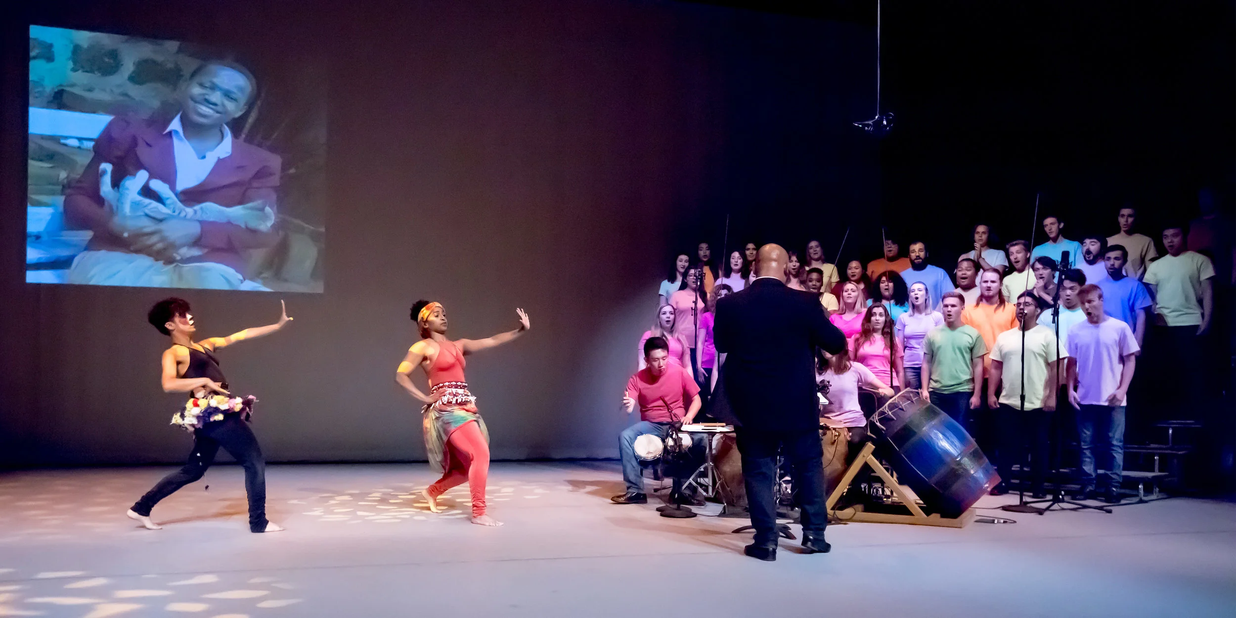Anindo Marshall choreographed "The Cat's Protector," based on a folk tale from Tanzania. Seen above, Nateli Ruiz and Shannon Grayson dance on stage with the choir.