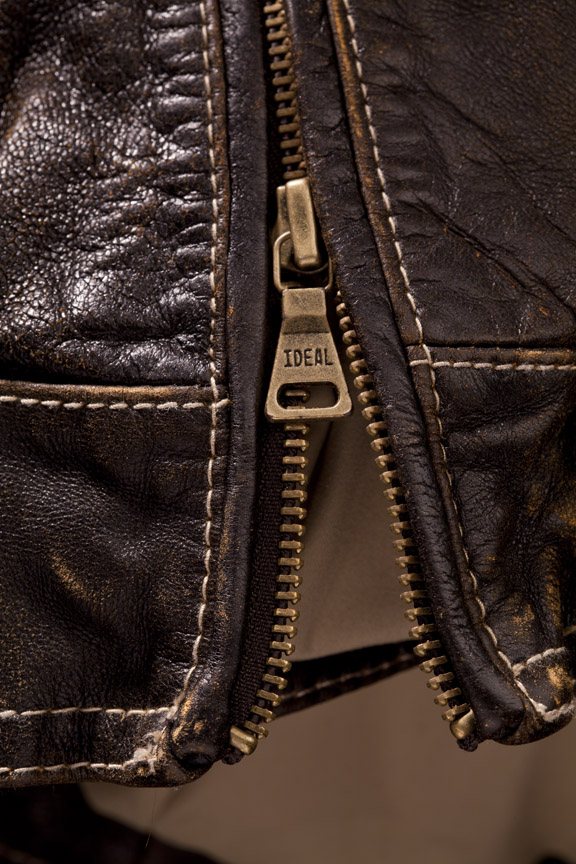 Men's leather jacket zipper close-up. 