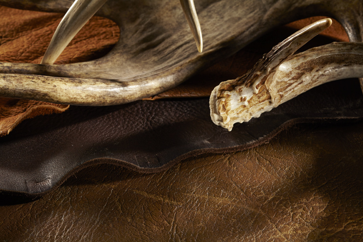 Elk antlers displayed on leather furniture swatches. 