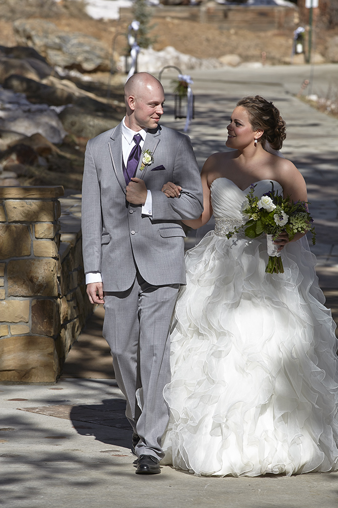 Brother escorting bride in outdoor wedding in Estes Park. 