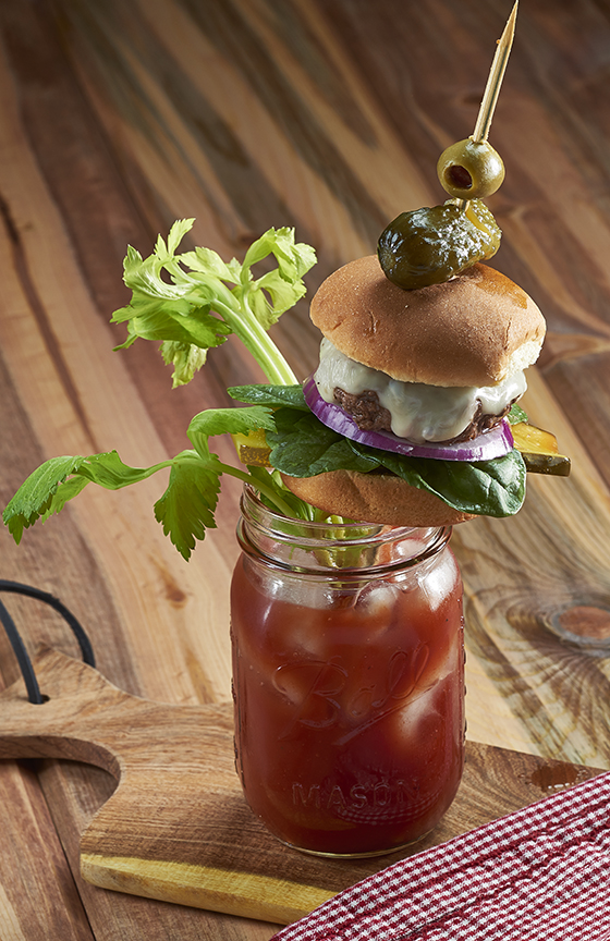 Bloody Mary with buffalo slider, pickle and celery garnish. 