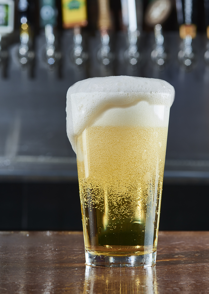 Foaming glass of beer. 