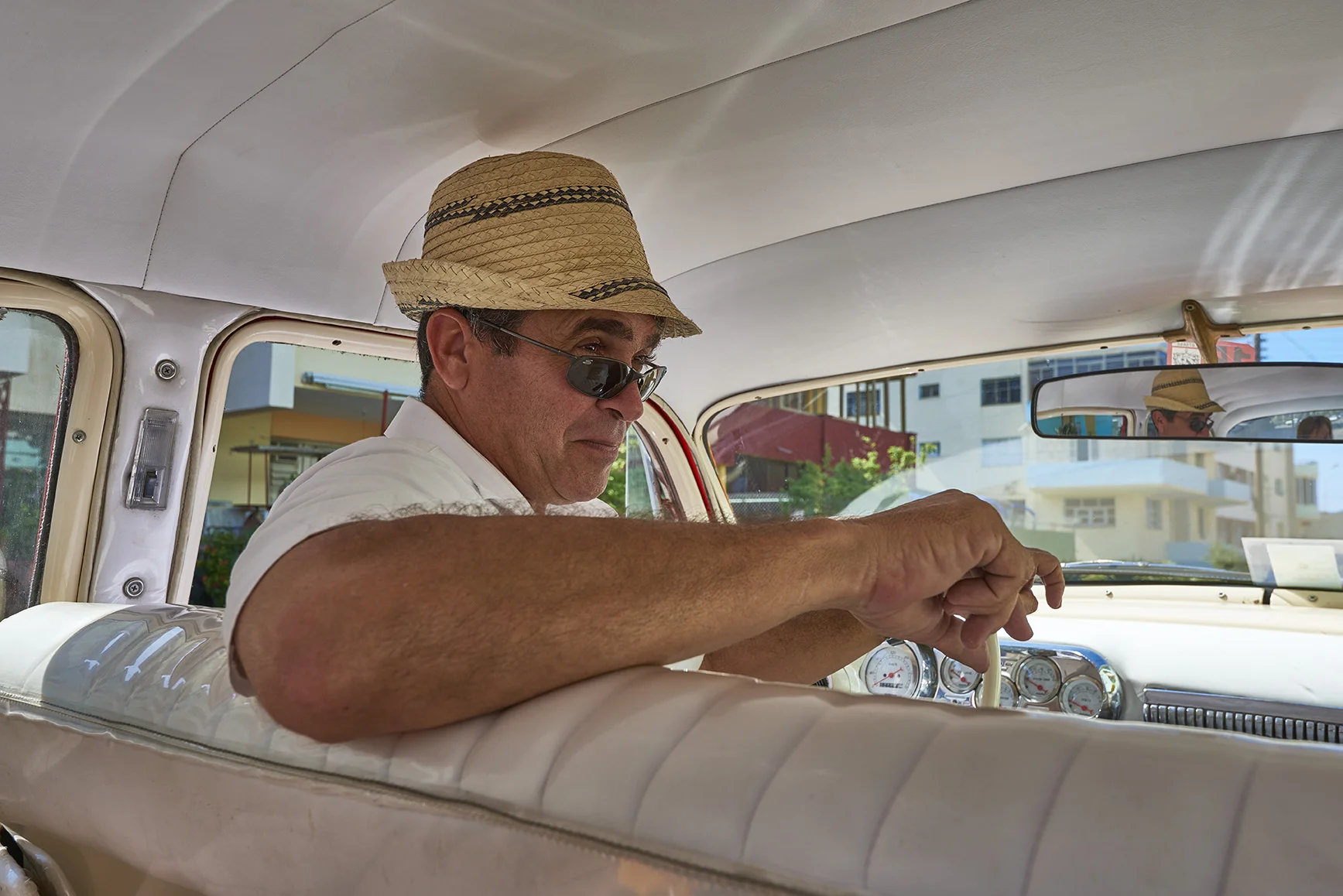 Cuban vintage taxi driver portrait.