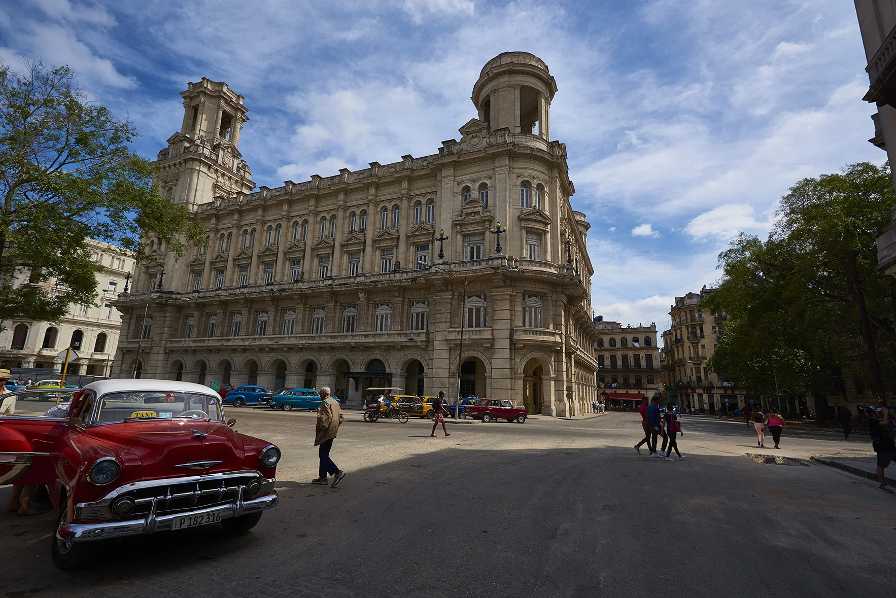 Havana, Cuba - square, architecture, red vintage taxi. 