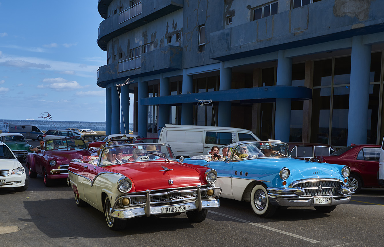 Vintage taxis filled with tourists in Havana, Cuba. 