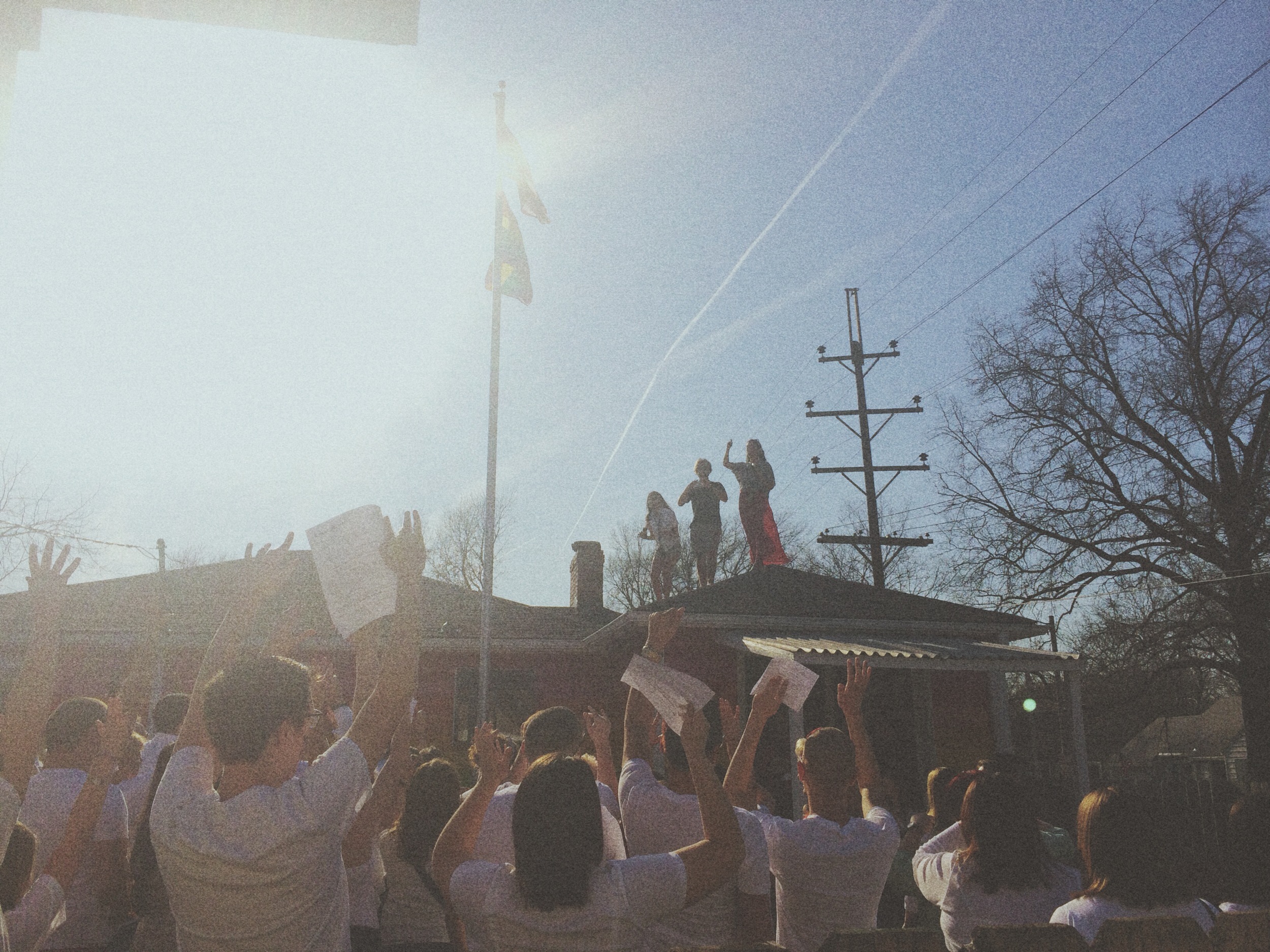 Amelia, Matt and Kristen on the roof of the Equality House taking a photo of the participates in the NOH8 campaign. 