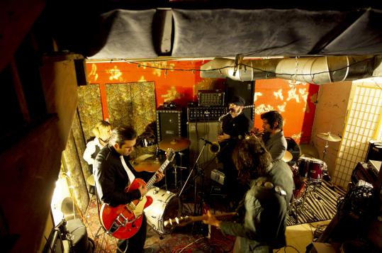 Photo of the original Trabants line-up rehearsing in our old practice space. Taken by and published in the Boston Globe.
