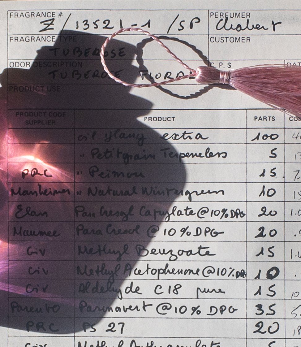 Close-up of Ava-Fleur flacon and handwritten formula, glowing with sunlight and artisanal detail.