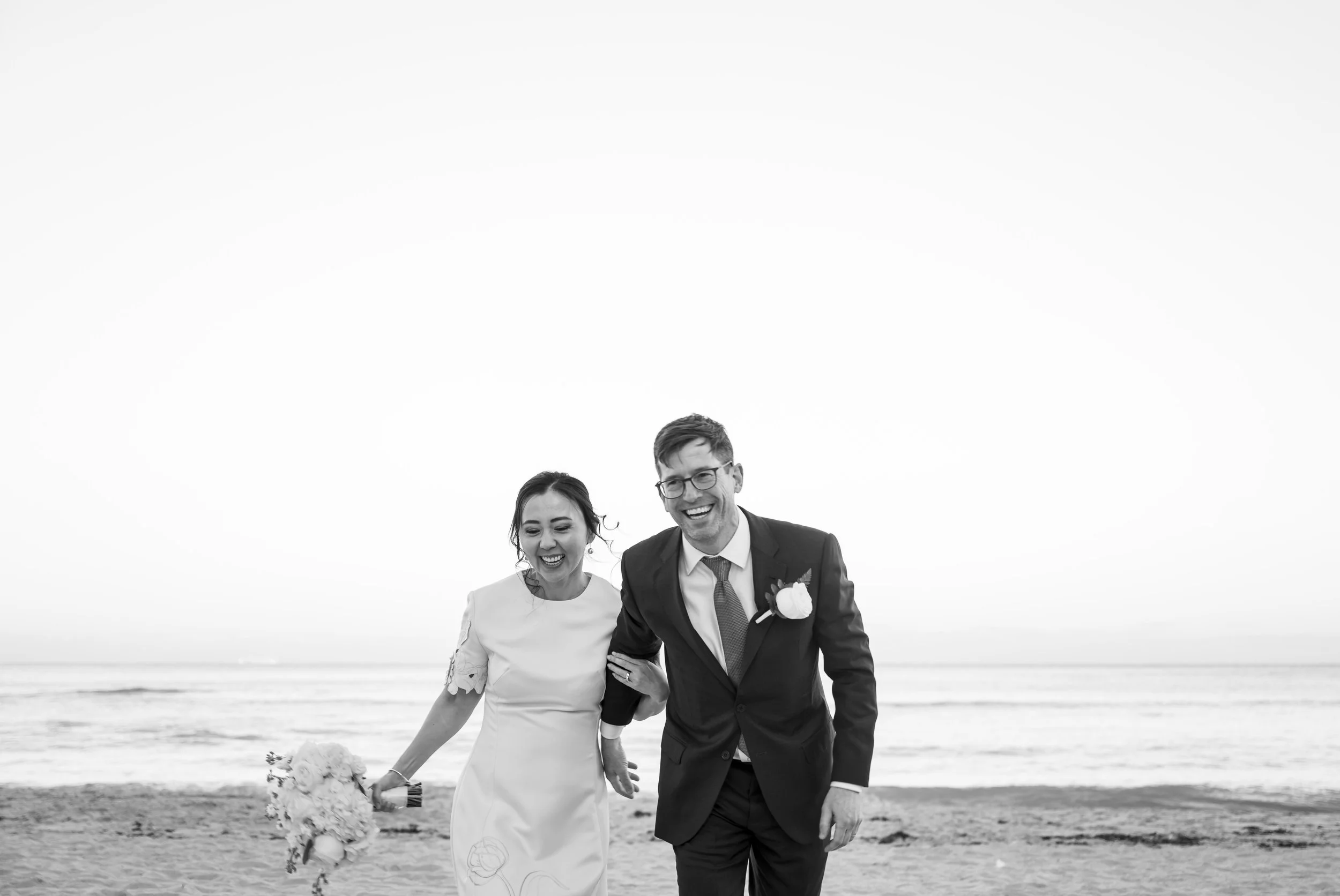 Destination South Florida Beach Wedding A Happy Bride and Groom Running On The Beach Laughing At The Sole Miami Beach A noble hotel