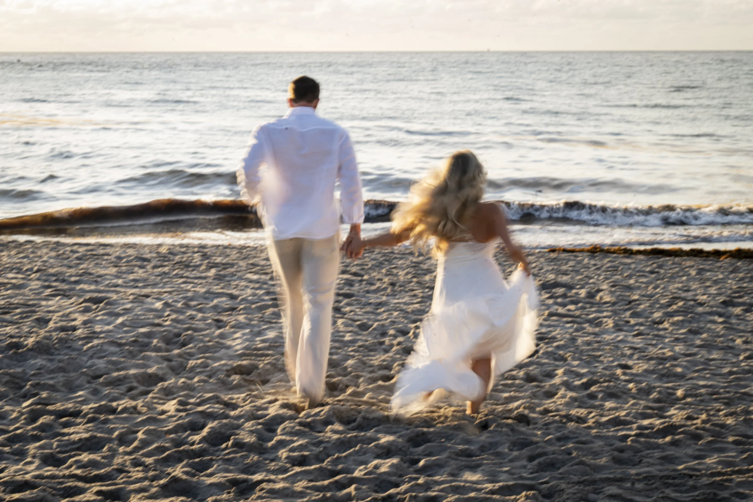 Beach Wedding in Boca Raton Couple running on the beach creating motion