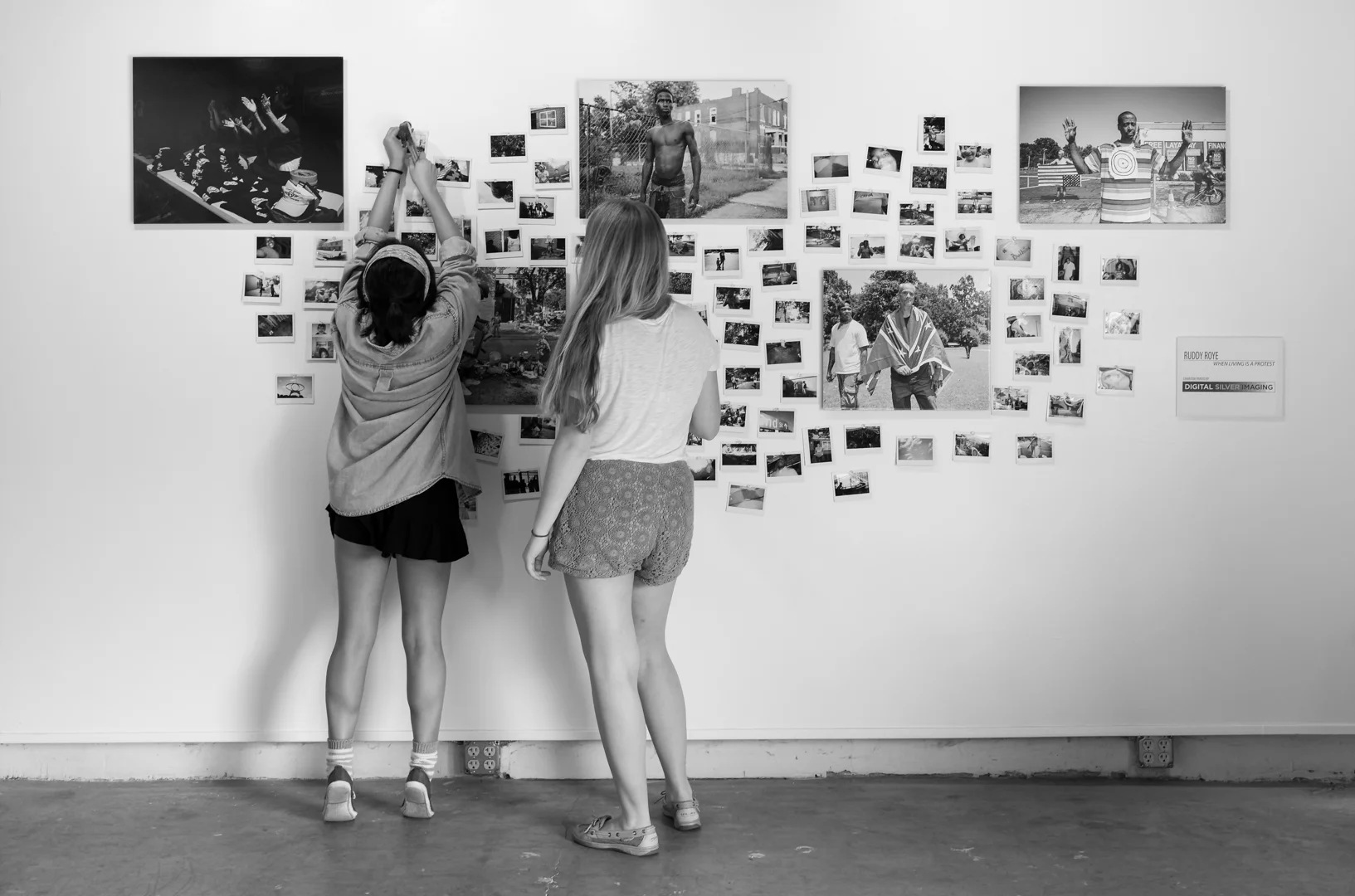 Ruddy Roye’s workshop students hang their polaroids up on one of the walls in Roye’s exhibition space. Photo © Keith Alan Sprouse