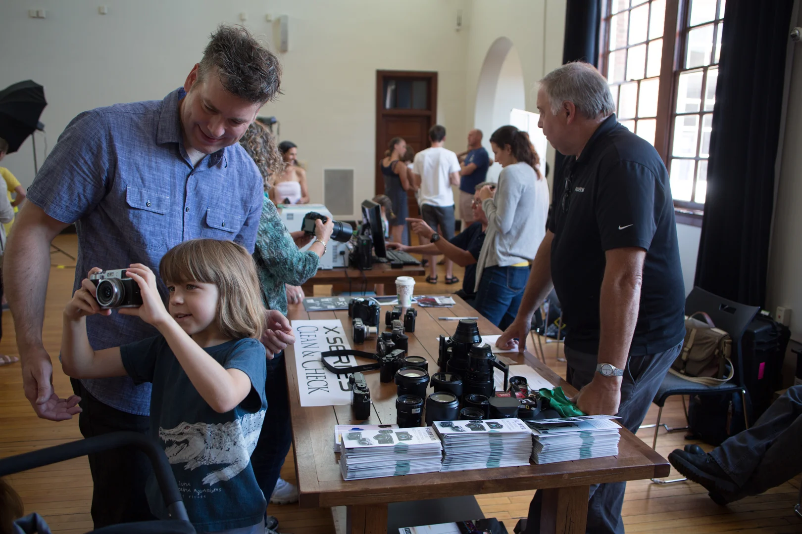 Community members visit Fujiphoto USA's table during Family Photo Day at the Jefferson School African American Heritage Center Photo © Jon Golden