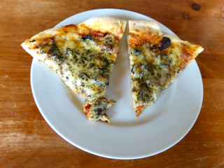 Pizza with mushrooms, black olives, onions, and sun-dried tomatoes. Baked on the Big Green Egg. Photo by Sue Van Slooten