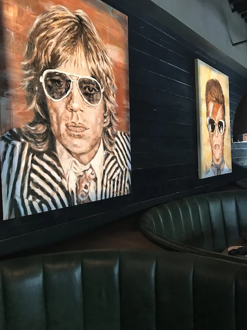 7 musicians of past and present by Carrie Penley line the walls