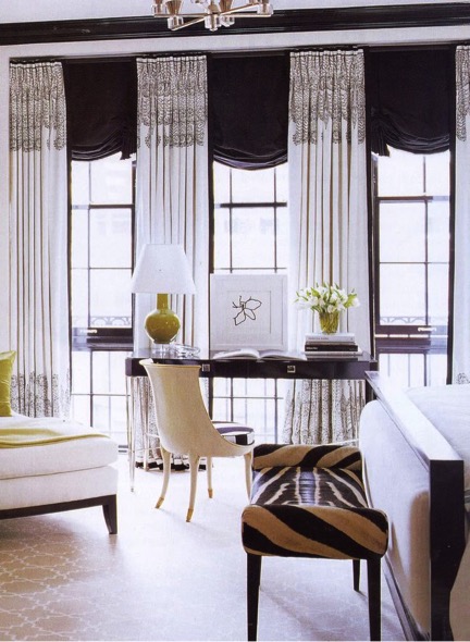 Black roman shades. Black and white embroidered draperies. Zebra hide bench. It takes traditional shapes and concepts, and tweaks them in a modern and fresh way. Love.