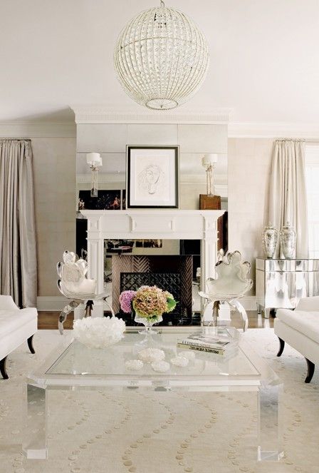 This space shows an interesting application of mirrors - on the fireplace, making it a focal point. Notice the sconces. 