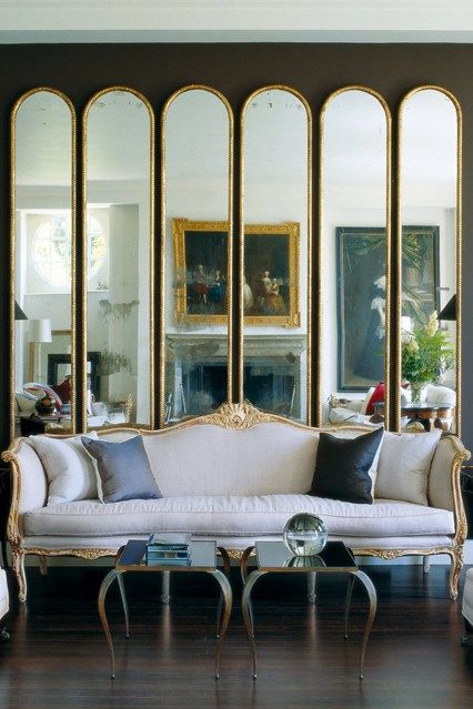You don't have to adhere the mirrors to your walls to make a statement. Here's a mirrored screen. Now the artwork in the background can be seen twice!