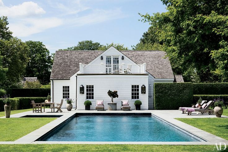 A classic Hamptons home is the perfect visual to start us off! I find myself drawing inspiration from the Hamptons quite frequently. Love this pool with coping that meets the grass. This clever installation of concrete pads for the furniture allows for easier maintenance and a very structured looking pool deck. .