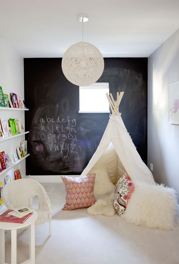 This room uses an overall neutral color palette and lets the children's toys and books bring in pops of color. Love the idea of using a collection of toys or books to create art on the walls. The chalk wall has become a classic feature in children's spaces.