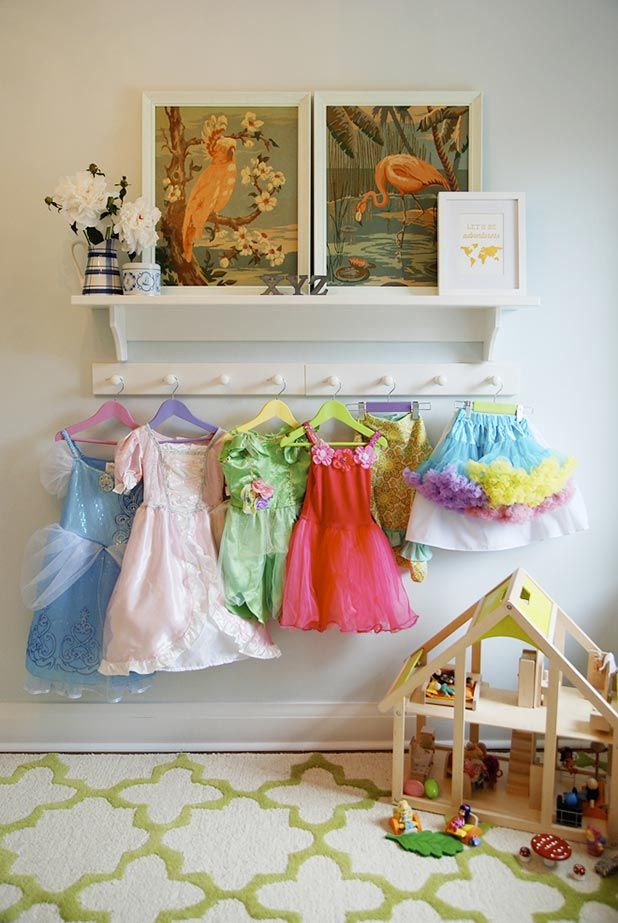 Such a simple idea here. Anyone can do this. Display play clothes on hooks to encourage cleaning up after play time is over!