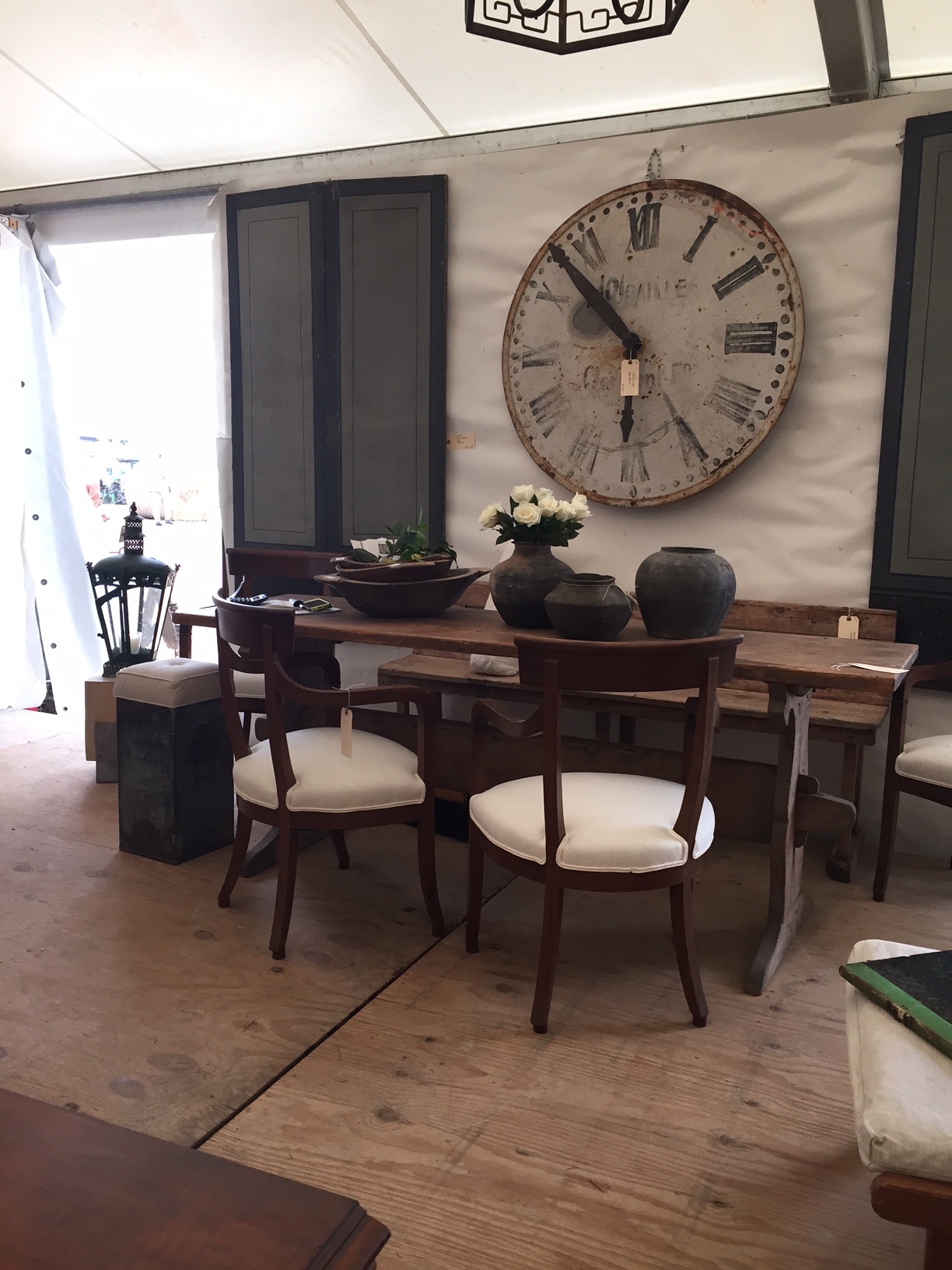 Black pottery looks great as a collection on this table. Love the oversized clock. There are a couple black pots left for sale. www.tiffanyfarhadesign.com/shop/