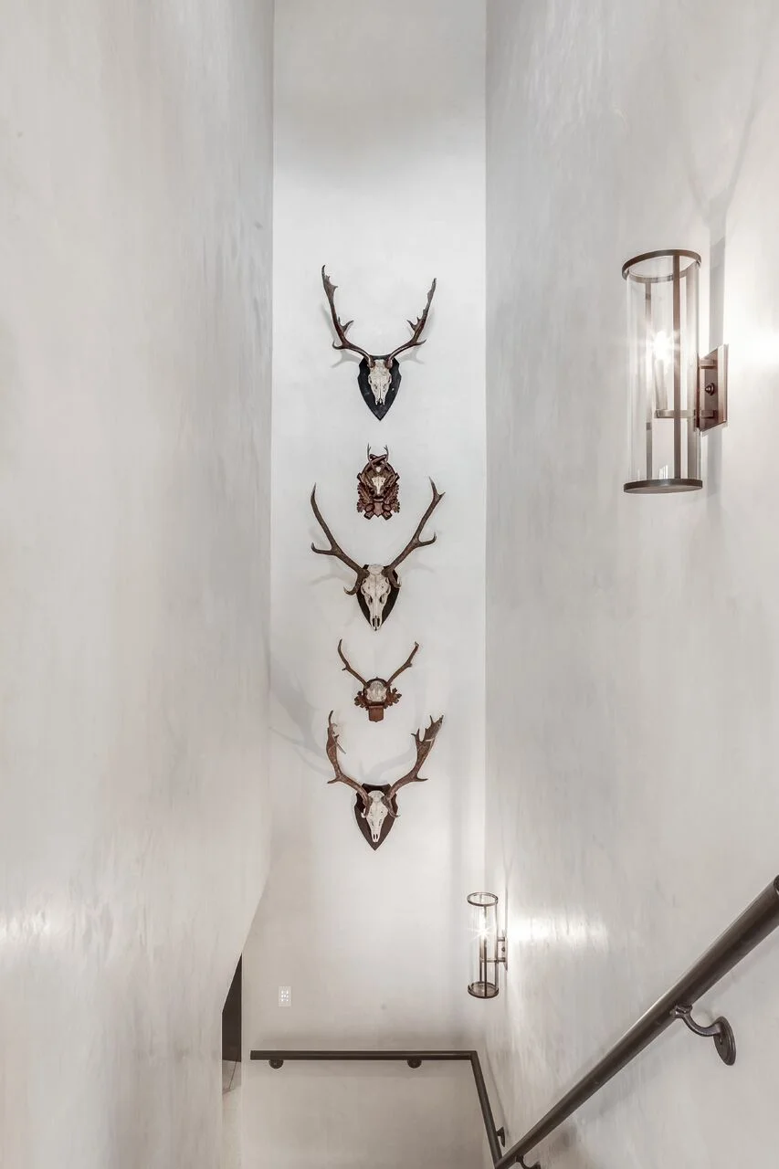 Stacking a row of vintage antler mounts was the perfect way to add visual interest to these white plaster walls. I can find a home for these anywhere. They bring the perfect amount of rustic luxe to any space. These Black Forest Antler Mounts are straight from the antique market!