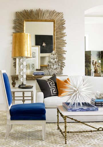 You know how much I like my white rooms...but this blue chair breathes life into the room and really packs a punch!