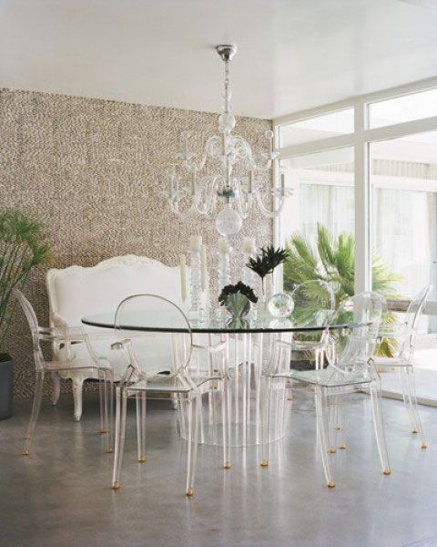 A traditional banquette, modern glass table, and lucite ghost chairs. With so many layers, the lucite chairs bring translucent function.