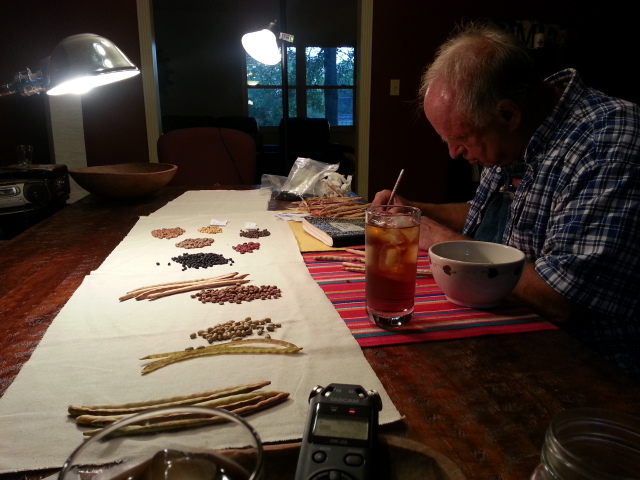 Heirloom seed saver John Coykendall at my kitchen table, sharing his knowledge of seed saving with us. He is here writing down histories, stories, and names of some of his collection of filed peas.